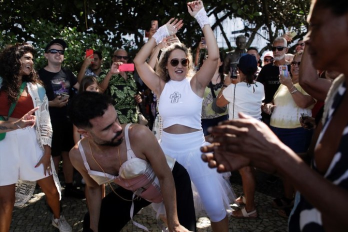 Madonna fans dance outside Copacabana Palace hotel where Madonna is staying ahead of her Celebration tour concert in Rio de Janeiro, Brazil, Friday, May 3, 2024. Madonna will conclude her tour on Saturday with a free concert at Copacabana Beach. (AP Photo/Bruna Prado