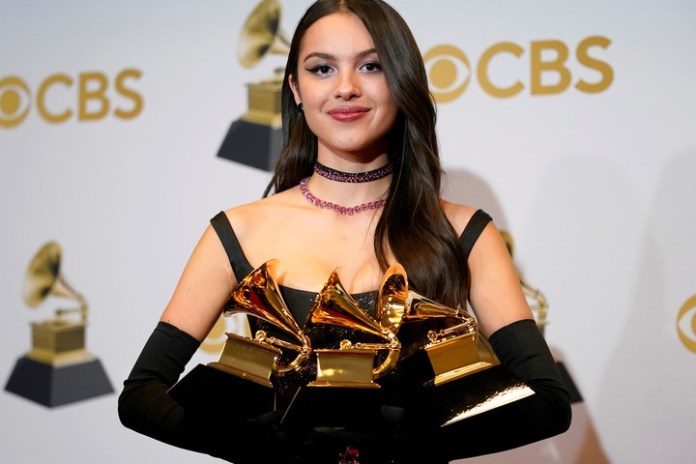 Olivia Rodrigo, con los tres premios que ganó en la última entrega de los Grammy. Foto AP 